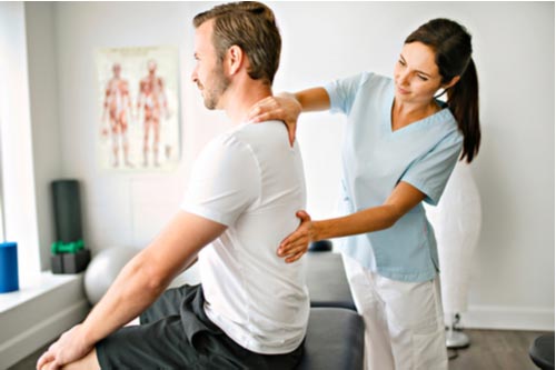 Young man getting chiropractic care for muscle strains