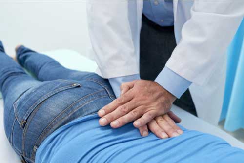 Chiropractor performs adjustment for Fort Myers back injury treatment