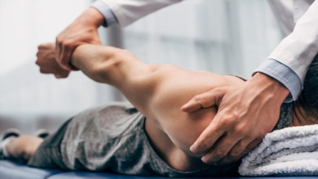 Selective Focus Chiropractor Stretching Patient's Arm
